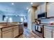 This open kitchen features stainless steel appliances, granite countertops, and a seamless flow to the living area at 6648 Castle Green Pl, Zephyrhills, FL 33541