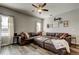 Comfortable living room features a large sectional sofa, ceiling fan, and decorative wall art at 6648 Castle Green Pl, Zephyrhills, FL 33541