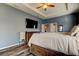The main bedroom showcases a TV, ceiling fan, and lots of space for furniture and accessories at 6648 Castle Green Pl, Zephyrhills, FL 33541