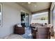 Relaxing covered patio with comfortable wicker furniture and blue patterned rug at 6648 Castle Green Pl, Zephyrhills, FL 33541