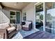 This is a view of a patio area with lovely wicker furniture and tile flooring at 6648 Castle Green Pl, Zephyrhills, FL 33541