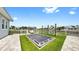 Spacious backyard with in-ground trampoline, sitting area, and beautiful landscaping at 718 Pinckney Dr, Apollo Beach, FL 33572