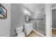 Bathroom featuring gray walls, a vanity with a white sink, a toilet, and a glass shower at 718 Pinckney Dr, Apollo Beach, FL 33572