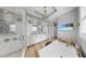 Beautiful bathroom with a glass shower, soaking tub, and double vanity with modern fixtures at 718 Pinckney Dr, Apollo Beach, FL 33572