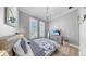 Bedroom with patterned bedding, window shutters, light hardwood floors, and ceiling fan at 718 Pinckney Dr, Apollo Beach, FL 33572