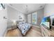 Coastal bedroom with a patterned bedspread, hardwood floors, and beachy decor at 718 Pinckney Dr, Apollo Beach, FL 33572