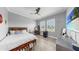 Bedroom with a modern ceiling fan, large windows, and a dresser with a TV at 718 Pinckney Dr, Apollo Beach, FL 33572