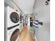 Organized closet with laundry featuring a stacked washer and dryer and custom shelving at 718 Pinckney Dr, Apollo Beach, FL 33572