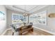 Sunlit dining space with wooden table and views of Apollo Beach at 718 Pinckney Dr, Apollo Beach, FL 33572