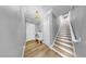 Bright entryway with hardwood floors, bench seating, and a staircase at 718 Pinckney Dr, Apollo Beach, FL 33572