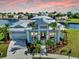Stunning exterior elevation with meticulous landscaping and a paver driveway at 718 Pinckney Dr, Apollo Beach, FL 33572