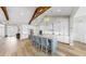 Bright and airy kitchen featuring white cabinetry, stainless steel appliances, a large island and wooden beam at 718 Pinckney Dr, Apollo Beach, FL 33572