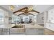 Gourmet kitchen with stone countertops, stainless steel sink, and a seamless view of the cozy living room at 718 Pinckney Dr, Apollo Beach, FL 33572