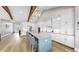 Bright, modern kitchen with a large island, stainless steel appliances, and elegant wooden beam details at 718 Pinckney Dr, Apollo Beach, FL 33572