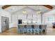 Spacious kitchen featuring stainless steel appliances, a large island, breakfast bar and custom cabinetry and lighting at 718 Pinckney Dr, Apollo Beach, FL 33572