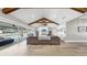 Bright living room with vaulted ceilings, exposed wood beams, and a seamless transition to the outdoor patio at 718 Pinckney Dr, Apollo Beach, FL 33572