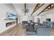 Stylish living room featuring vaulted ceilings, wooden beams, a cozy fireplace, and an open design concept at 718 Pinckney Dr, Apollo Beach, FL 33572