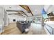 Inviting living room featuring a fireplace, hardwood floors, exposed beams, and access to the outdoor living space at 718 Pinckney Dr, Apollo Beach, FL 33572