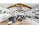 Open-concept living space with exposed beams, modern ceiling fan, recessed lighting, and oversized sectional sofa at 718 Pinckney Dr, Apollo Beach, FL 33572