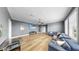 Spacious living room with wood floors, a ceiling fan, and large windows with natural light at 718 Pinckney Dr, Apollo Beach, FL 33572