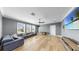 Spacious living room with wood floors, a ceiling fan, and large windows with natural light at 718 Pinckney Dr, Apollo Beach, FL 33572