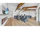 Open-concept living space with vaulted ceilings, wood beams, fireplace, and seamless flow to the modern kitchen at 718 Pinckney Dr, Apollo Beach, FL 33572