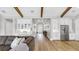 An open concept living room, dining room, and kitchen area with hardwood flooring and stainless appliances at 718 Pinckney Dr, Apollo Beach, FL 33572