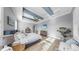 Comfortable main bedroom with trey ceiling, seating, and light wood floors at 718 Pinckney Dr, Apollo Beach, FL 33572