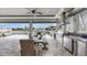 Fully equipped outdoor kitchen and dining area overlooking the water at 718 Pinckney Dr, Apollo Beach, FL 33572