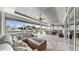 Spacious outdoor living area with a fireplace, dining table, and summer kitchen at 718 Pinckney Dr, Apollo Beach, FL 33572