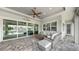 Covered patio with ceiling fan, outdoor seating area, and sliding glass doors at 718 Pinckney Dr, Apollo Beach, FL 33572