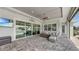 Covered patio with ceiling fan, outdoor seating area, and sliding glass doors at 718 Pinckney Dr, Apollo Beach, FL 33572