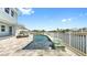 Beautiful pool overlooking waterfront with lounge seating and privacy fence at 718 Pinckney Dr, Apollo Beach, FL 33572