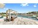 Luxury outdoor pool with covered lounge area and lush landscaping at 718 Pinckney Dr, Apollo Beach, FL 33572