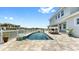 Inviting pool with lounge seating, covered daybed and waterfront views at 718 Pinckney Dr, Apollo Beach, FL 33572
