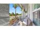 Relaxing front porch featuring stone flooring, decorative railings, pillars, a bench, and views of the neighborhood at 718 Pinckney Dr, Apollo Beach, FL 33572