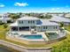 Aerial view of backyard featuring an outdoor pool, covered lanai, and waterfront views of the canal at 718 Pinckney Dr, Apollo Beach, FL 33572