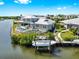 Beautiful home with a private dock, boat lift, backyard pool, and covered patio overlooking serene waters at 718 Pinckney Dr, Apollo Beach, FL 33572