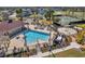 Aerial view of a community pool and recreation area with tennis courts, splash pad, and seating at 7711 Nottinghill Sky Dr, Apollo Beach, FL 33572