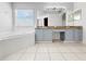Large bathroom with tiled floor, corner bathtub and double vanity with a granite countertop at 7711 Nottinghill Sky Dr, Apollo Beach, FL 33572