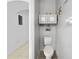 Cozy powder room featuring a standard toilet with stylish wall-mounted shelving for storage and decoration at 7711 Nottinghill Sky Dr, Apollo Beach, FL 33572
