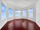 This bonus room features hardwood floors, recessed lighting and natural light from large bay windows at 7711 Nottinghill Sky Dr, Apollo Beach, FL 33572