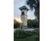 A clock tower in a community showcasing stone and stucco architecture set within a landscaped garden at 7711 Nottinghill Sky Dr, Apollo Beach, FL 33572