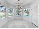 Bright dining area overlooking the pool with abundant natural light and tile flooring at 7711 Nottinghill Sky Dr, Apollo Beach, FL 33572