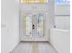 Front door with decorative glass and transom windows at 7711 Nottinghill Sky Dr, Apollo Beach, FL 33572