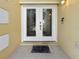 Elegant double front doors with decorative glass, set in a stucco exterior at 7711 Nottinghill Sky Dr, Apollo Beach, FL 33572