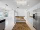 Large kitchen island with granite countertop and decorative lighting offers ample prep space and elegance at 7711 Nottinghill Sky Dr, Apollo Beach, FL 33572