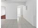 Bright room with tile floors, an archway, and neutral paint at 7711 Nottinghill Sky Dr, Apollo Beach, FL 33572
