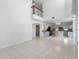 Expansive open-concept living space with high ceilings, seamlessly connecting to the well-appointed kitchen area at 7711 Nottinghill Sky Dr, Apollo Beach, FL 33572