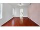 Bright room with hardwood floors, large windows, and decorative lighting at 7711 Nottinghill Sky Dr, Apollo Beach, FL 33572